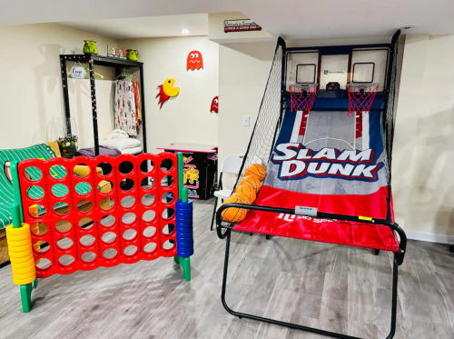 A game room featuring a basketball arcade game and a colorful connect-four style game.