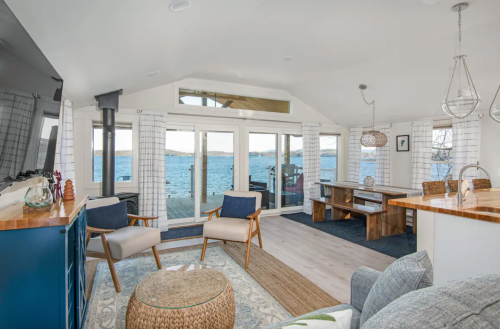 Bright, modern living room with lake views, featuring comfortable seating and natural light.