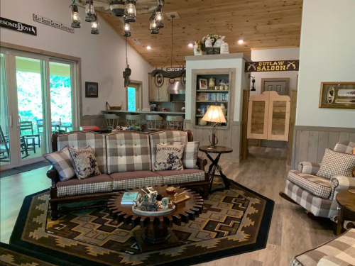 Cozy living room with plaid furniture, wooden accents, and a rustic decor theme, featuring a warm, inviting atmosphere.