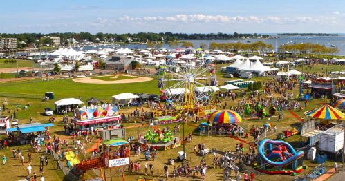 Aerial shot of the annual oyster festival in norwalk ct with amusement park rides and vendor tents im veterans memorial park