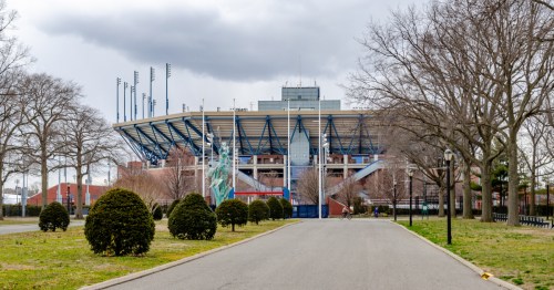 exterior entrance of Arthur Ashe Stadium in Flushing, New York on a cloudy day