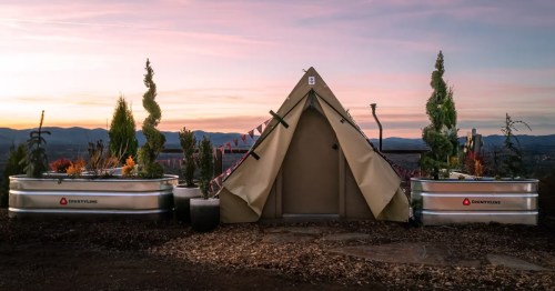 a tent outside an airbnb during sunset