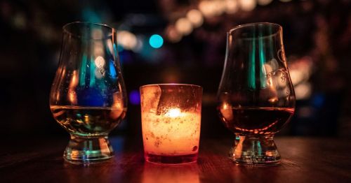 Two glasses of whiskey and a candle in Arkansas