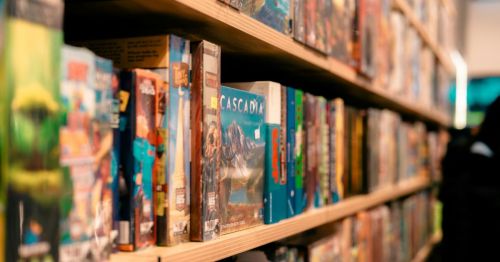 A wooden shelf with board games