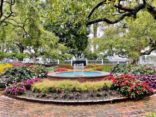 A serene garden with a central fountain surrounded by colorful flowers and lush greenery under a cloudy sky.