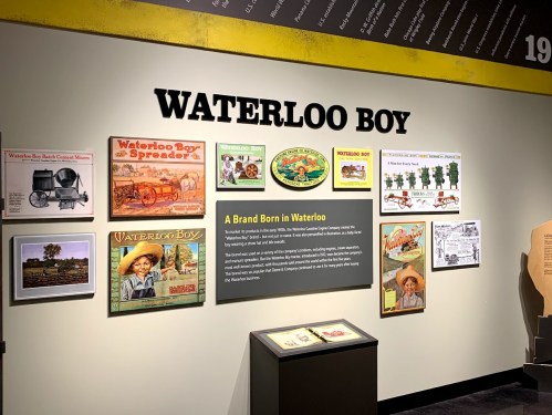 Exhibit wall featuring "Waterloo Boy" history with images, text, and illustrations about its origins and significance.