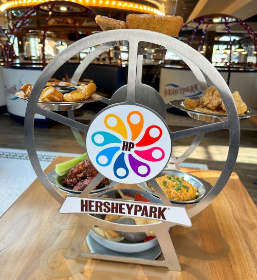 A colorful food display shaped like a Ferris wheel, featuring various snacks and the Hersheypark logo.