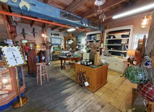 A cozy antique shop filled with nautical decor, wooden furniture, and various collectibles on display.