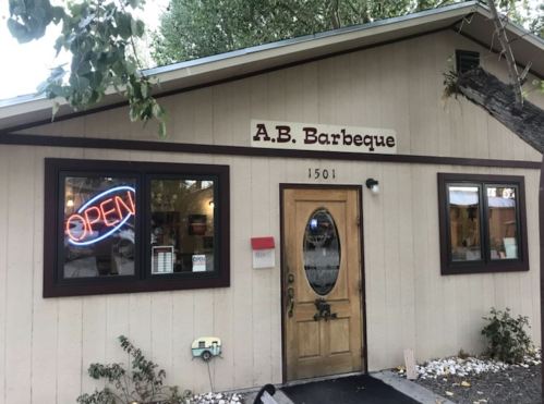 A.B. Barbeque restaurant exterior with an "OPEN" sign in the window and a welcoming entrance.