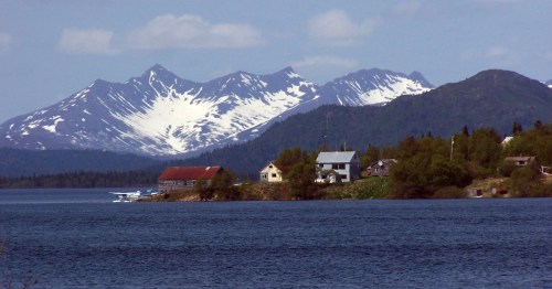 Aleknagik, Alaska with snow covered mountains in the distance.