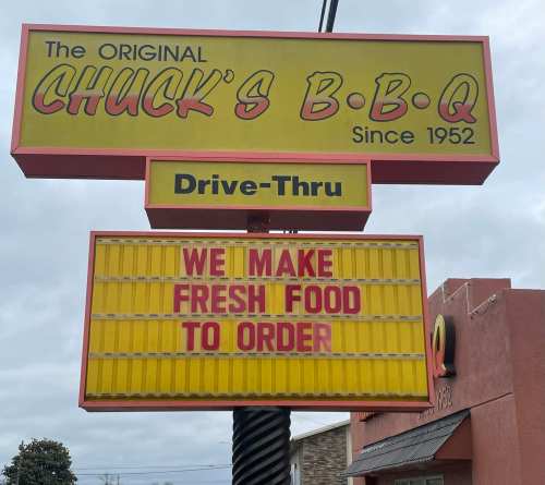 Sign for Chuck's B.B.Q. featuring "We make fresh food to order" and drive-thru information.