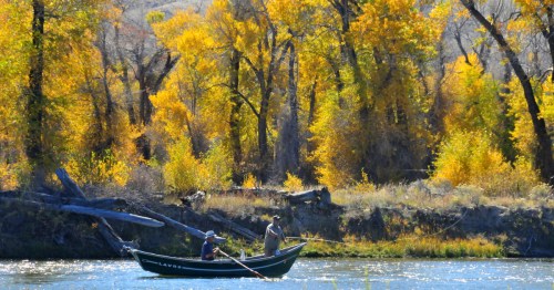 Two people fishing from a boat at the seedskadee national wildlife refuge in Wyoming.