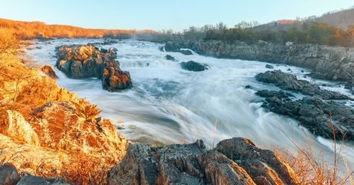 Sunset view of the rushing waterfall in the Great Falls of the Potomac in Maryland