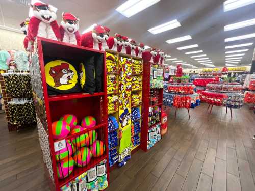 A colorful store display featuring plush toys, beach balls, and various merchandise on shelves and racks.