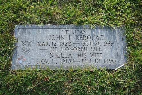 Gravestone of John L. Kerouac and his wife Stella, with dates of birth and death, surrounded by grass and coins.