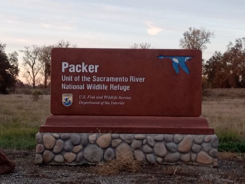 Sign for Packer Unit of the Sacramento River National Wildlife Refuge, featuring a blue bird graphic and official logos.