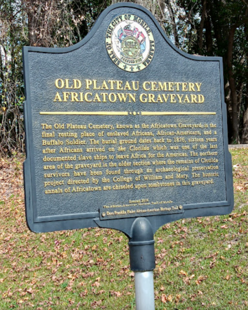 Sign detailing the history of Old Plateau Cemetery, also known as Africatown Graveyard, and its significance to African American heritage.