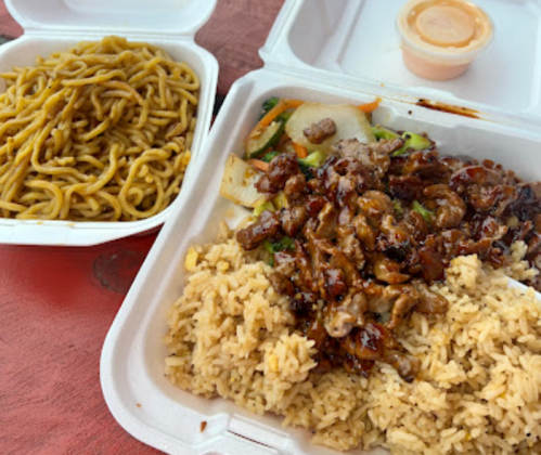 A takeout meal featuring rice, beef, vegetables, and a side of noodles in white containers.