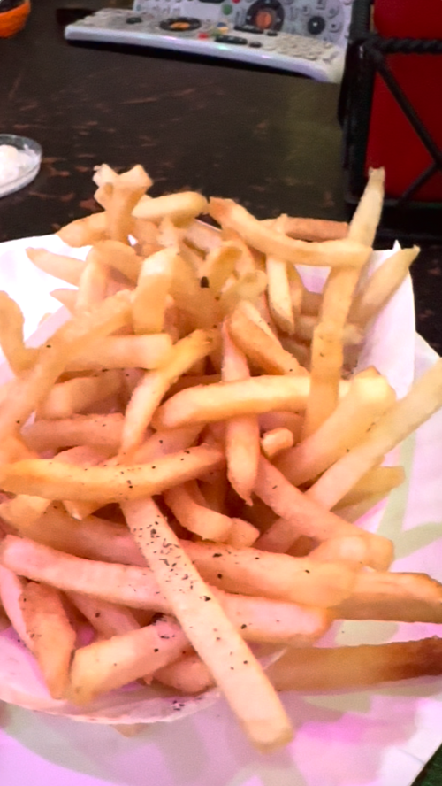 A heaping serving of golden, crispy French fries on a plate.