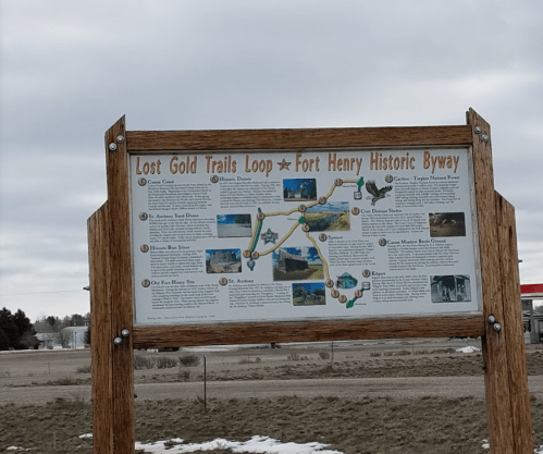 Sign for the Lost Gold Trails Loop and Fort Henry Historic Byway, featuring a map and information about the area.