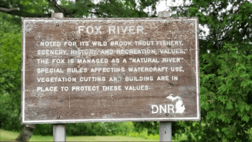 Sign for Fox River highlighting its natural values, fishery, and regulations for watercraft use and vegetation protection.