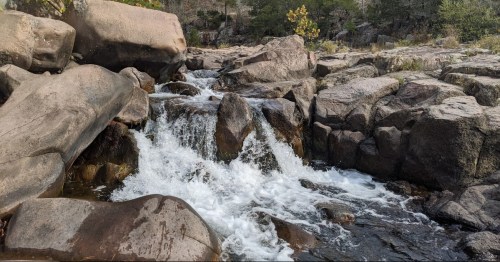 Small waterfalls spilling over rocks along the Old Hahn Mills trail in Missouri.