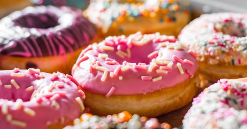 Close up of colorful donuts with sprinkles on top