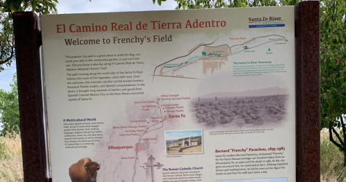 Sign for El Camino Real de Tierra Adentro, detailing Frenchy's Field and its historical significance near Santa Fe.