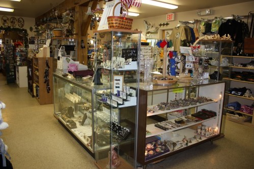 A gift shop interior featuring display cases filled with jewelry, souvenirs, and various decorative items.