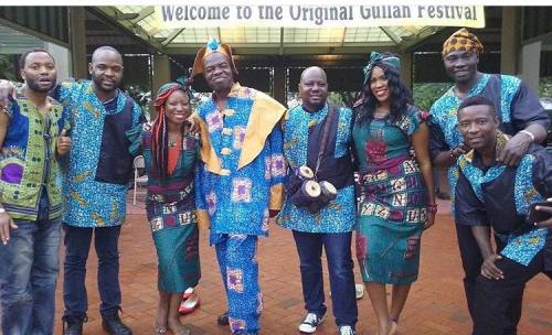 A group of people in colorful traditional outfits poses together at the Original Gulu Festival.