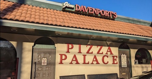 Exterior of a restaurant named "Pizza Palace" with a sign reading "Jim Davenports" above the entrance.