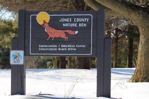 Sign for Jones County Nature Den featuring a fox illustration, with details about conservation and education services.