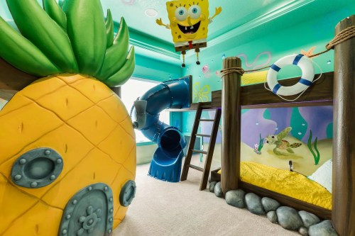 A colorful children's room featuring a SpongeBob-themed bunk bed, slide, and pineapple-shaped play area.