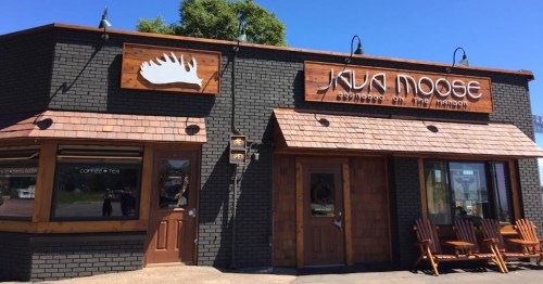 Exterior of Java Moose coffee shop, featuring wooden accents and a moose logo, with a welcoming entrance.