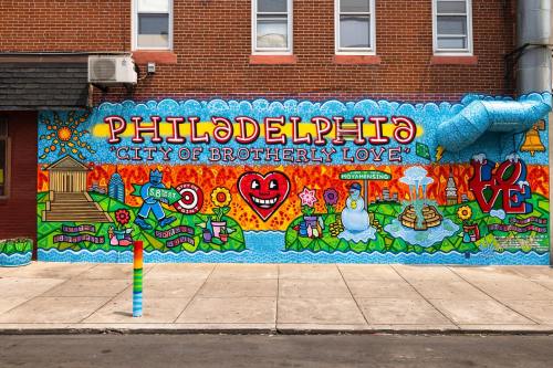 Colorful mural in Philadelphia featuring the phrase "City of Brotherly Love" with vibrant designs and symbols.