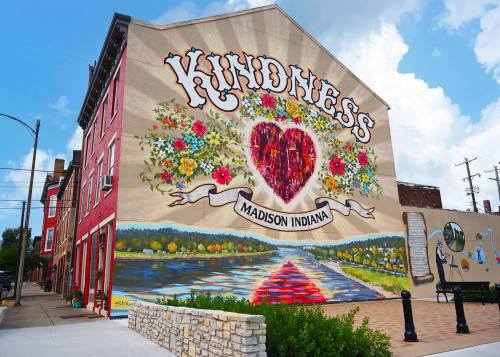 Colorful mural on a building in Madison, Indiana, featuring the word "Kindness" and a heart surrounded by flowers.
