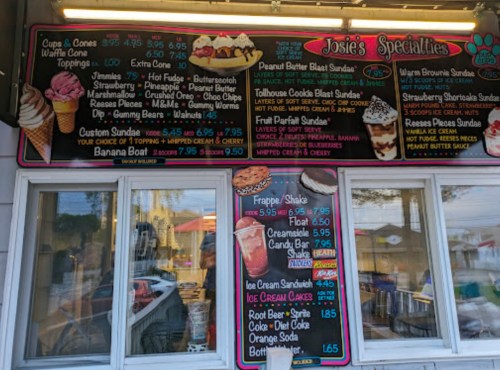 Menu board featuring ice cream options, sundaes, shakes, and prices at Josie's Specialties. Colorful and inviting design.