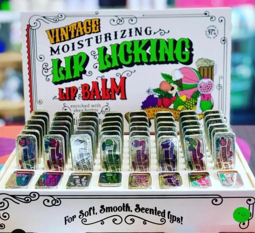 Display of vintage lip balm tins in colorful packaging, labeled "Moisturizing Lip Licking Lip Balm."