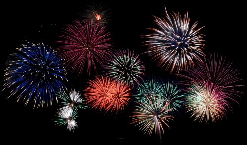 A vibrant display of colorful fireworks bursting in various shapes against a dark night sky.