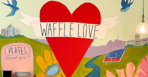 Colorful mural featuring a large red heart with "Waffle Love" text, surrounded by flowers and birds.
