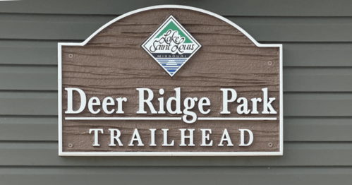 Sign for Deer Ridge Park Trailhead at Lake St. Louis, Missouri, featuring a logo and wooden design.