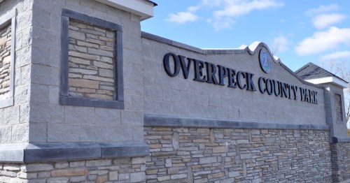 Sign for Overpeck County Park, featuring stonework and a blue sky in the background.