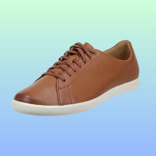 Brown leather sneaker with white sole, set against a gradient blue-green background.