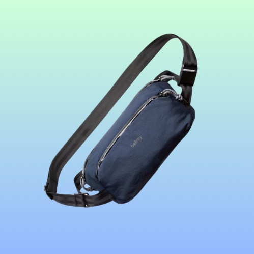 A navy blue sling bag with a sleek design and adjustable strap, set against a gradient background.