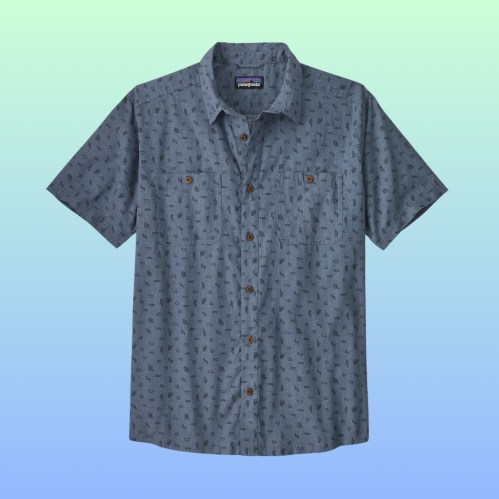 Short-sleeve button-up shirt with a blue pattern, featuring two chest pockets and brown buttons, set against a gradient background.
