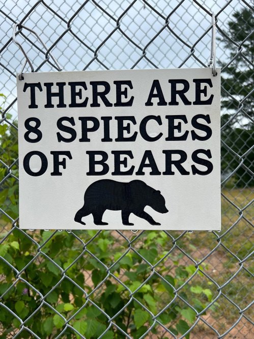 Sign on a fence stating, "There are 8 species of bears," with a silhouette of a bear.