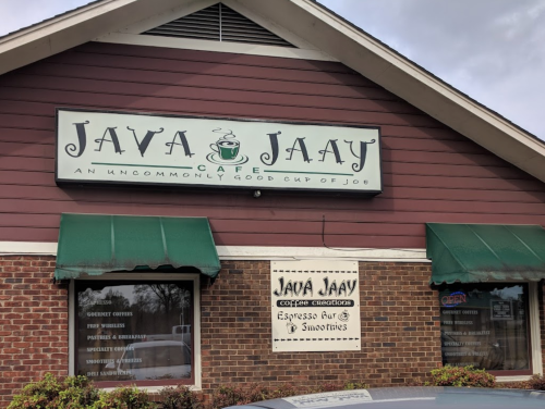 Sign for Java Jaay Cafe, featuring "An Uncommonly Good Cup of Joe" and details about coffee and smoothies.