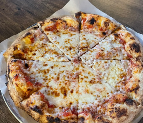 A freshly baked cheese pizza, sliced into eight pieces, with a golden crust and melted cheese on top.
