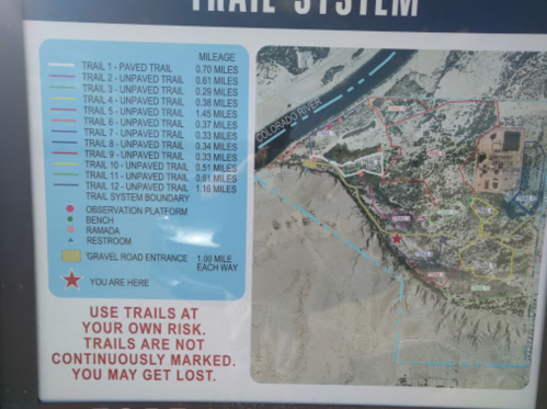 Map of a trail system showing various trails, distances, and key features like restrooms and observation platforms.