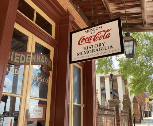 Sign for the Museum of Coca-Cola, featuring history memorabilia and offering ice cream and Coke floats.
